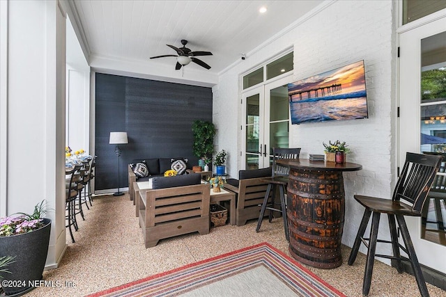 view of patio with a bar, ceiling fan, and an outdoor living space