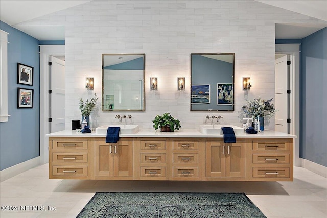 bathroom with vanity, tile patterned flooring, tasteful backsplash, and lofted ceiling