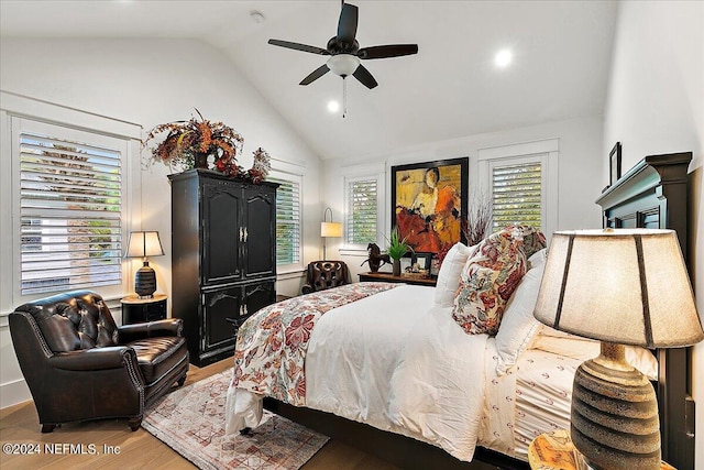 bedroom with vaulted ceiling, ceiling fan, and light hardwood / wood-style floors