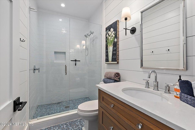 bathroom featuring walk in shower, vanity, and toilet