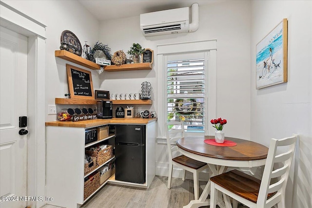 bar featuring butcher block countertops, a wall unit AC, and light wood-type flooring