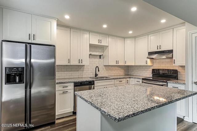 kitchen featuring sink, appliances with stainless steel finishes, light stone countertops, white cabinets, and dark hardwood / wood-style flooring