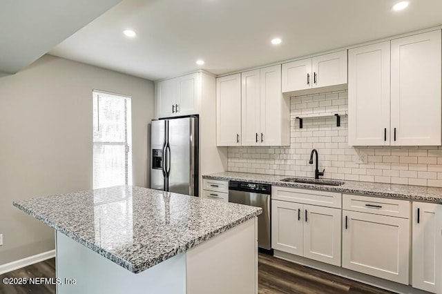 kitchen featuring sink, stainless steel appliances, dark hardwood / wood-style floors, and white cabinets