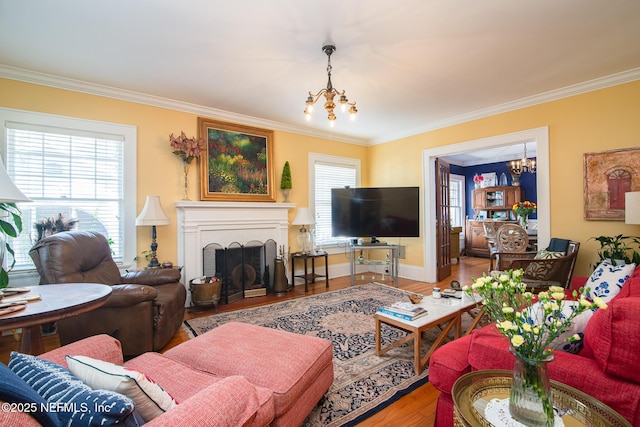 living room with a notable chandelier, ornamental molding, and hardwood / wood-style floors