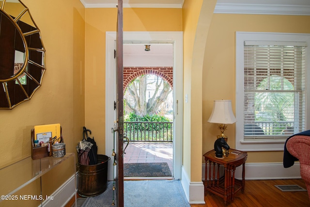 doorway featuring hardwood / wood-style flooring and ornamental molding