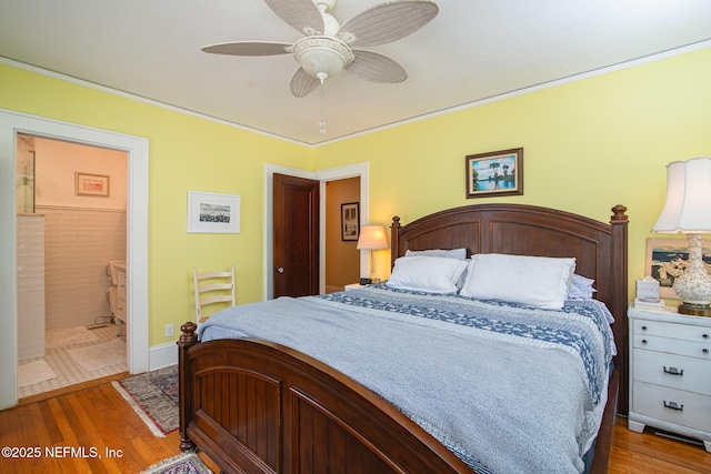 bedroom featuring crown molding, connected bathroom, hardwood / wood-style flooring, and ceiling fan