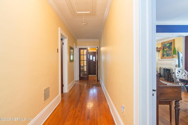 hall featuring crown molding and dark wood-type flooring