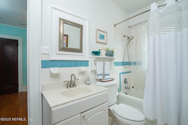 full bathroom with toilet, tasteful backsplash, tile walls, vanity, and shower / bath combo with shower curtain