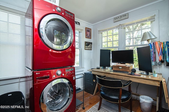 laundry area featuring hardwood / wood-style flooring and stacked washing maching and dryer