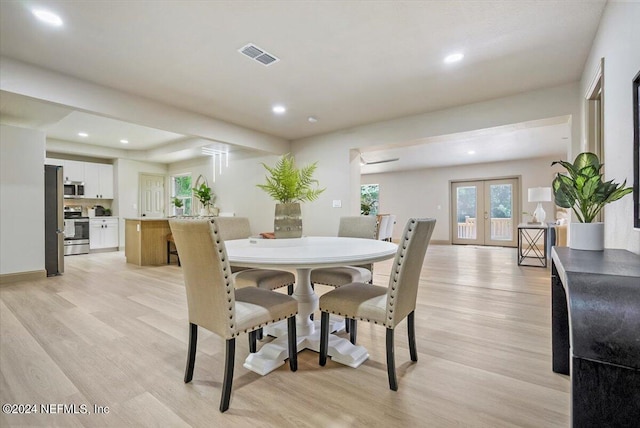 dining area featuring light hardwood / wood-style flooring and french doors