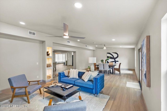 living room with ceiling fan and light hardwood / wood-style floors