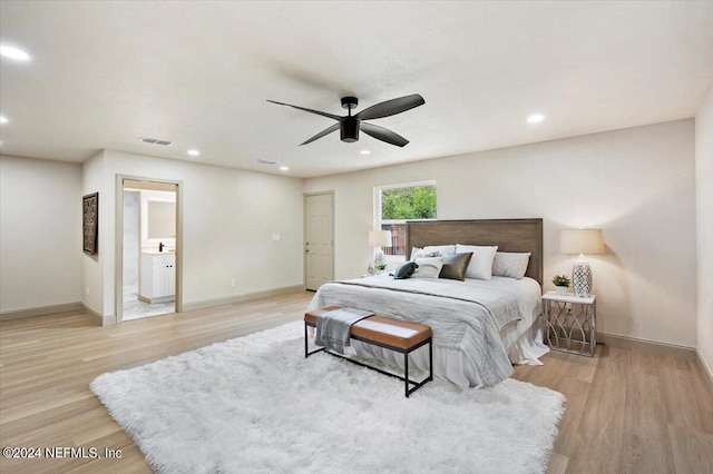 bedroom featuring ceiling fan, connected bathroom, and light wood-type flooring