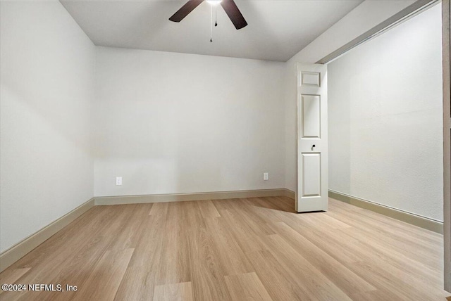 unfurnished bedroom with ceiling fan and light wood-type flooring