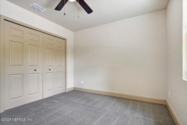 unfurnished bedroom with a closet, ceiling fan, and carpet flooring