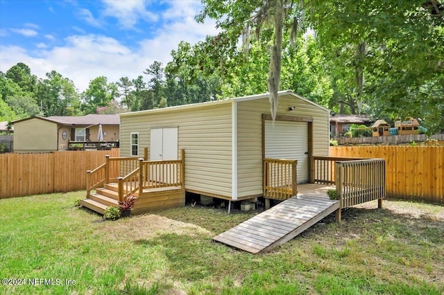 rear view of house featuring an outbuilding and a yard