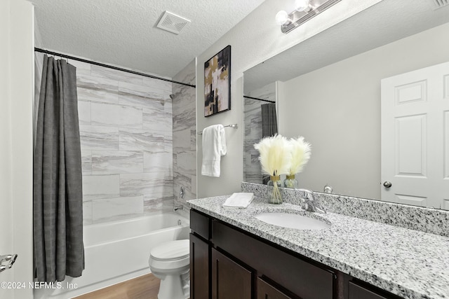 full bathroom featuring toilet, a textured ceiling, vanity, shower / bath combo with shower curtain, and hardwood / wood-style flooring