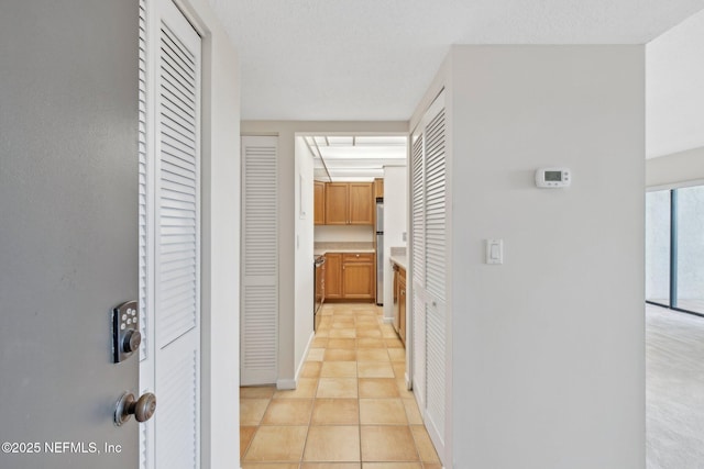 corridor featuring light tile patterned floors