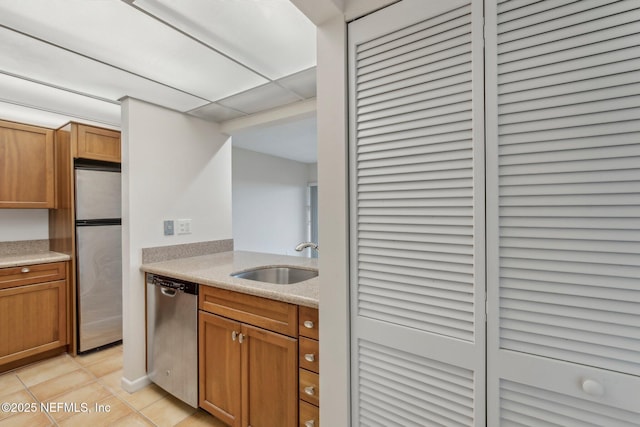 kitchen featuring light tile patterned flooring, appliances with stainless steel finishes, and sink