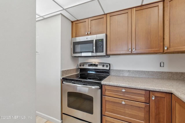 kitchen featuring a paneled ceiling and stainless steel appliances