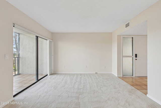 empty room featuring light colored carpet