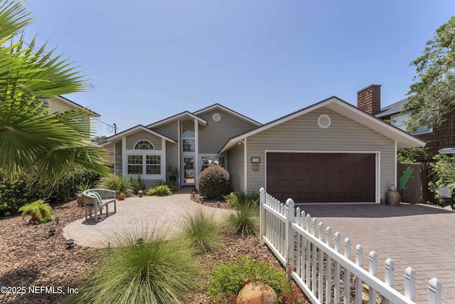 view of front of house with a garage and a patio area