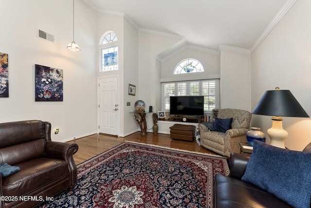 living room featuring high vaulted ceiling, hardwood / wood-style flooring, and ornamental molding