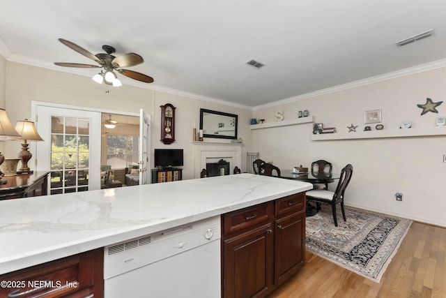 kitchen featuring light stone counters, light hardwood / wood-style flooring, ornamental molding, dishwasher, and ceiling fan