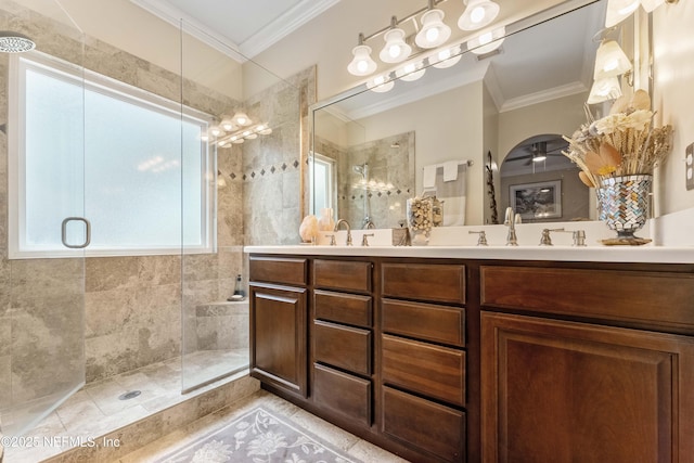 bathroom with vanity, crown molding, a shower with door, and ceiling fan