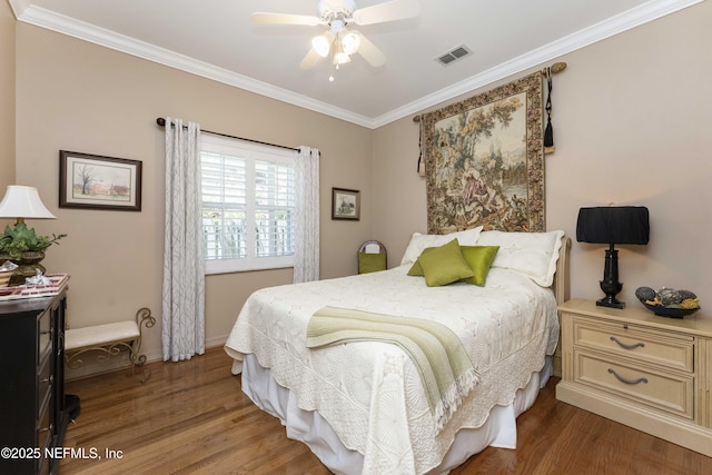 bedroom featuring crown molding, ceiling fan, and dark hardwood / wood-style flooring