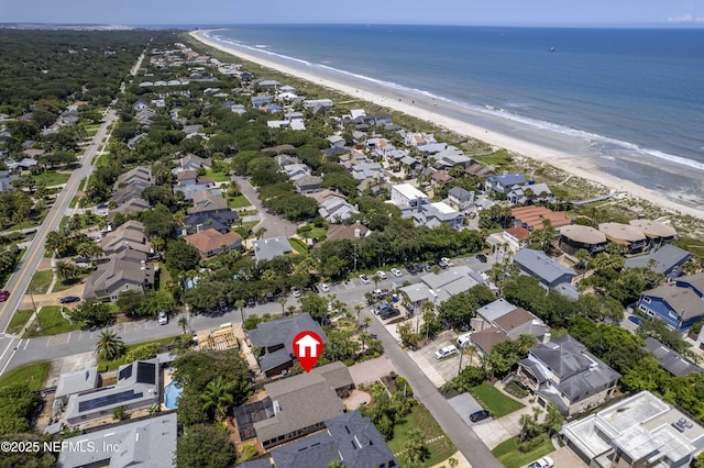 birds eye view of property featuring a water view and a view of the beach