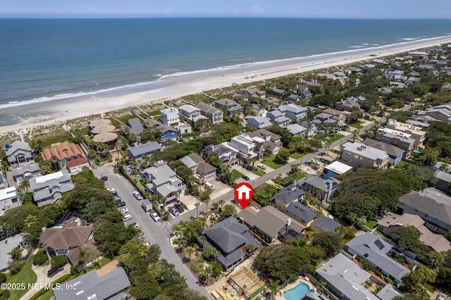 birds eye view of property with a beach view and a water view