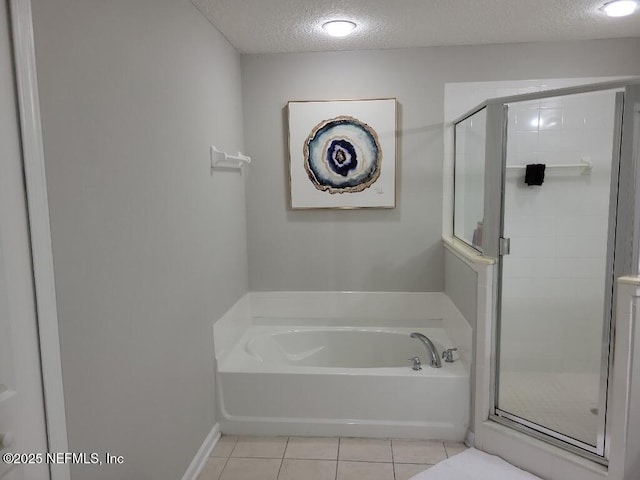 bathroom with tile patterned floors, independent shower and bath, and a textured ceiling