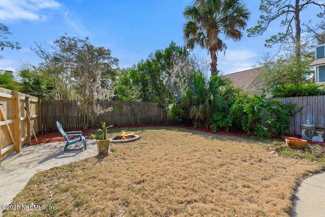 view of yard with a patio and an outdoor fire pit