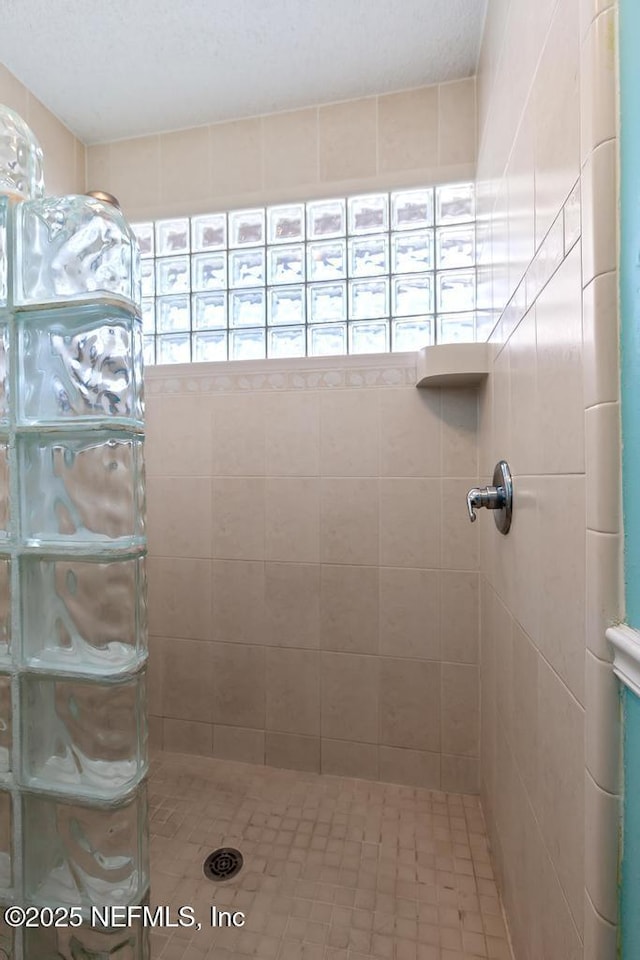 bathroom with tiled shower