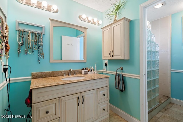 bathroom with vanity, tile patterned floors, and walk in shower