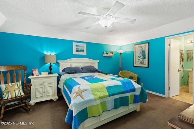 bedroom with dark colored carpet, ensuite bathroom, ceiling fan, and a textured ceiling