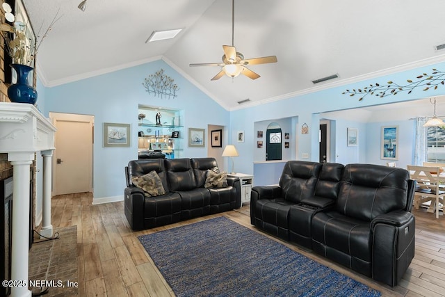 living room featuring high vaulted ceiling, ornamental molding, light hardwood / wood-style floors, and ceiling fan