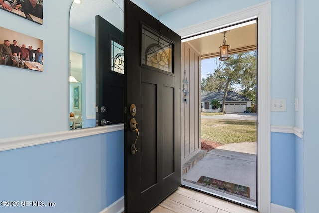 foyer entrance with light hardwood / wood-style floors