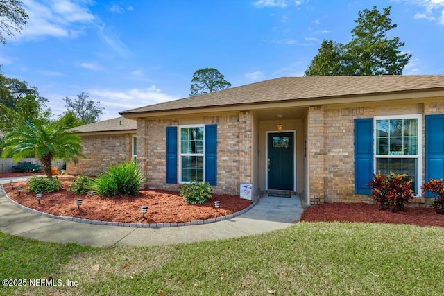 ranch-style home with a front lawn