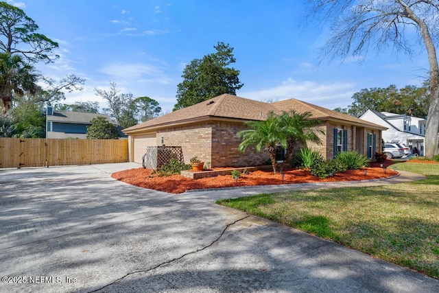 view of front of property with a garage and a front yard