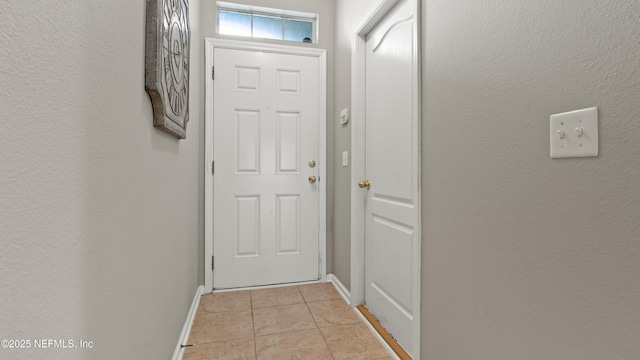 entryway with light tile patterned floors