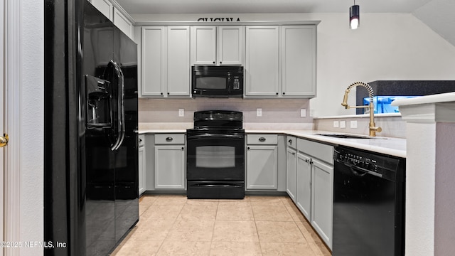 kitchen with sink, gray cabinetry, hanging light fixtures, light tile patterned floors, and black appliances