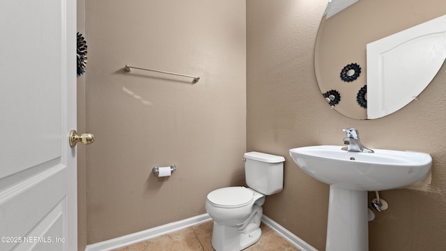 bathroom featuring tile patterned floors and toilet