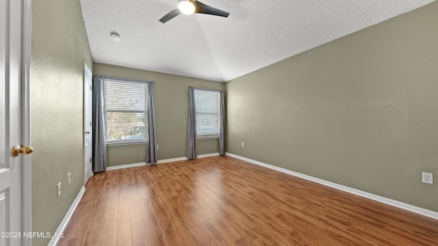 unfurnished room with ceiling fan, hardwood / wood-style floors, and a textured ceiling