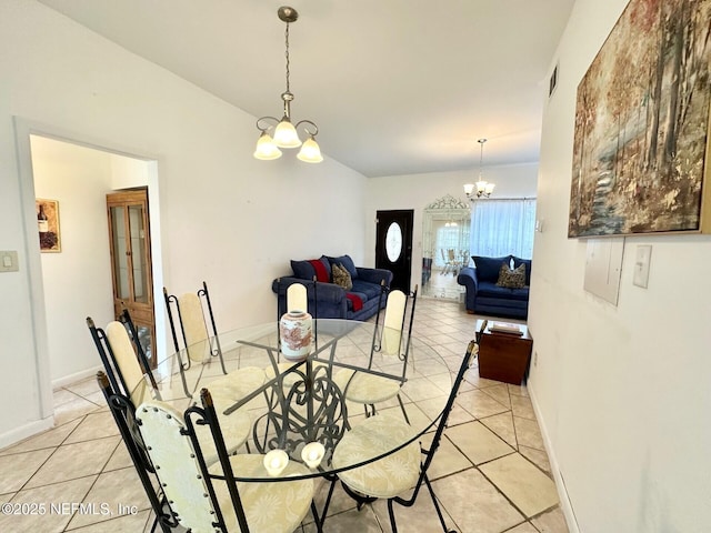 tiled dining space featuring an inviting chandelier