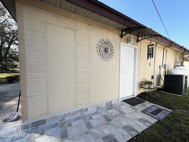 property entrance with central AC and a patio area