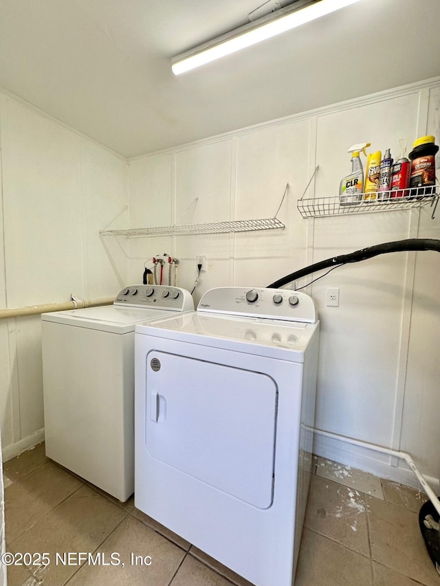 laundry area with light tile patterned floors and independent washer and dryer