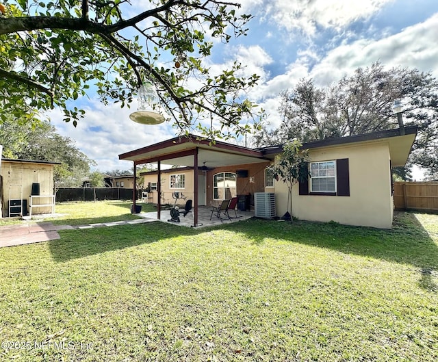 view of yard featuring ceiling fan, central AC unit, and a patio