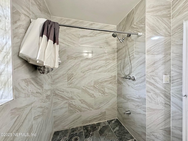 bathroom with a tile shower