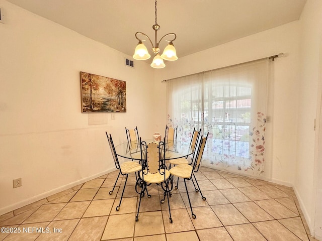 tiled dining area featuring a notable chandelier